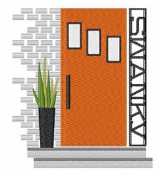 Modern front door in vibrant orange with sleek windows, accompanied by a black planter and a textured brick wall.