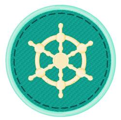 Nautical wheel emblem with a gold design on a teal background, featuring a decorative stitch outline.