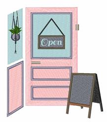 Colorful door with an 'Open' sign, a hanging plant in a macrame holder, and a sidewalk chalkboard.