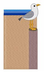 Whimsical seagull perched on a vertical support, set against a bright beach backdrop with sandy colors.