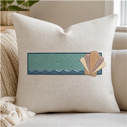 Contemporary pillow with decorative seashell embroidery, teal color block, soft fabric, perfect for summer decor.