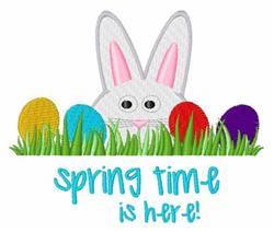 Playful white bunny with pink ears among colorful Easter eggs in green grass, perfect for spring festivities.