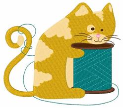 Playful yellow cat with a curly tail interacts with a bright blue spool of thread, perfect for embroidery.