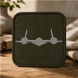 Minimalistic tools patch featuring gray embroidery on dark green fabric; simple and contemporary design.