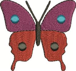 Applique butterfly with vibrant purple wings, blue dots, and an orange body, showcasing playful design.