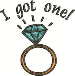 Cheerful engagement ring with a turquoise diamond on a gold band, featuring playful text 'I got one!' above.