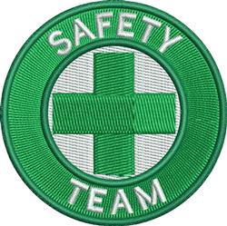 Safety patch featuring a bold green circular border, white 'SAFETY TEAM' text, and a medical cross.