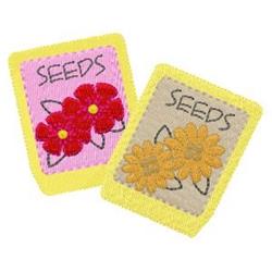 Two colorful seed packets featuring pink and red blooms alongside beige and yellow flowers, perfect for spring gardening.