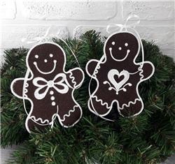 FSL gingerbread men with brown bodies, white accents, and festive green foliage backdrop.