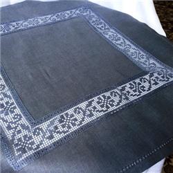 FSL decorative lace border design with intricate geometric patterns on dark fabric, showcasing elegant craftsmanship.
