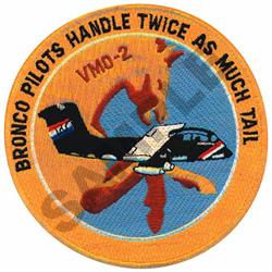 Bold military aircraft patch with vibrant blue and orange tones; features text encircling the design.