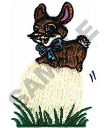 Cartoonish brown rabbit with a blue bow sitting on a yellow egg, surrounded by green grass for Easter.