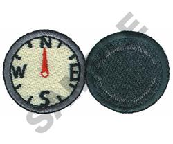 Realistic compass face with cardinal directions in black on beige, red needle pointing north, and a black border.