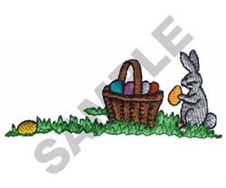 Cheerful rabbit in gray sits beside a woven basket filled with colorful Easter eggs on lush grass.