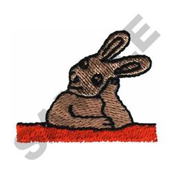 Playful rabbit with exaggerated features resting on a bright orange surface, perfect for spring-themed designs.