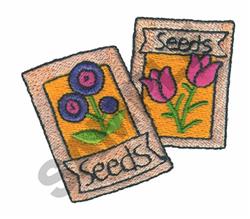 Colorful applique seed packets with blue flowers and pink tulips, featuring 'Seeds' labels, perfect for gardening.