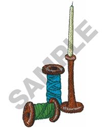 Spools of colorful thread in blue, green, and brown stacked near a slender needle, showcasing a crafting theme.