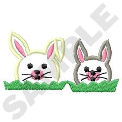 Playful white and gray bunnies peeking from lush green grass, perfect for cheerful Easter celebrations.