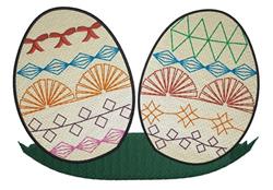 Colorful decorative Easter eggs with geometric patterns in red, blue, green, and orange on a grass base.