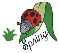 Playful red ladybug with black spots on a vibrant green leaf, surrounded by grass. Spring-themed embroidery design.