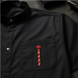 Barber pole in red and white embroidery on a modern black shirt pocket, showcasing a playful design.