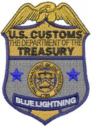 U.S. Customs shield badge featuring a gold eagle emblem, surrounded by blue stars and intricate details.