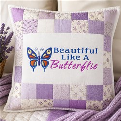 Butterfly design on a colorful patchwork pillow with purple patches and cheerful text, perfect for home decor.
