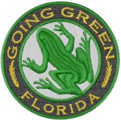 Colorful green frog patch featuring a vibrant frog at center, circular design, with 'GOING GREEN' text.