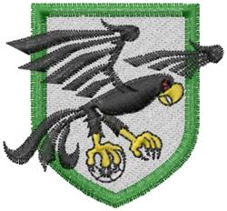 Intricate hawk-like bird with outstretched wings in bold black, set against a green-bordered gray shield.