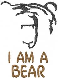 Playful bear face in black thread with expressive features and 'I AM A BEAR' in bold brown font.
