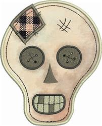 Applique skull with stitched button eyes and playful patch details, featuring a soft color palette for Halloween.