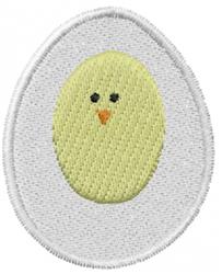 Cheerful chick in egg applique design, featuring a yellow chick with black eyes peeking from a white eggshell for Easter.