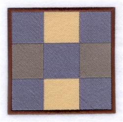 Patchwork square in blue, beige, and gray fabrics with a brown border, featuring a simple quilt design.