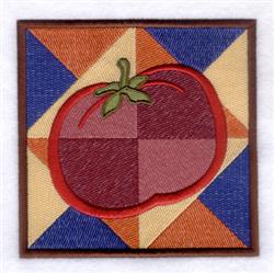 Vibrant quilt design featuring a red tomato with a green stem against a colorful patchwork background.