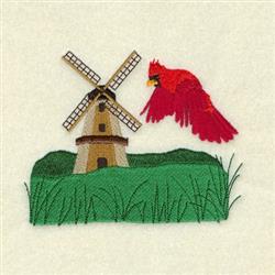 Colorful windmill with a cardinal bird in flight over lush green grass, perfect for spring decor.