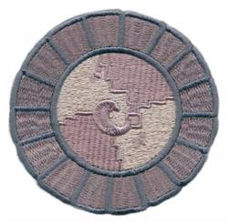 Circular embroidery patch with a light purple center, dark blue outlines, and a stylized 'C'. Modern and minimalist design.