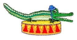 Playful green crocodile wearing a blue hat, sitting on a colorful drum with red triangles, perfect for kids.