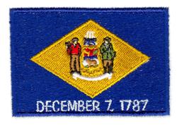 Delaware state flag in detailed applique design, featuring a yellow diamond, historical figures, and 'DECEMBER 7, 1787'.