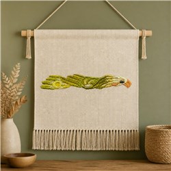 Bohemian wall hanging featuring an eagle with outstretched wings, fringing, and earthy tones of green and beige.