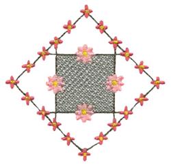 Floral design featuring pink flowers and a green vine in a whimsical diamond shape, perfect for spring quilting.