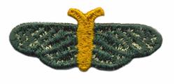 FSL moth with vibrant green wings and a bright yellow body, featuring textured stitching details.