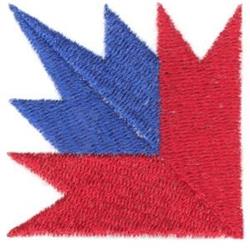 Bold geometric triangle shapes in red and blue create a dynamic quilted design with symmetrical movement.