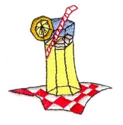 Tall glass of colorful lemonade with lemon slice and red straw on checkered tablecloth, perfect for summer refreshment.