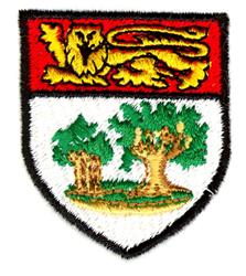 Traditional shield emblem featuring a detailed lion in red and gold with green trees on a golden ground.