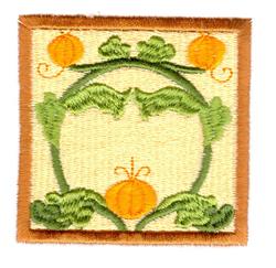 Whimsical pumpkin appliqué design with two vibrant pumpkins framed by lush green leaves and vines, perfect for fall.