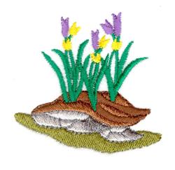 Colorful spring flowers in purple with yellow accents atop a brown shell resting in soil, showcasing cheerful nature.