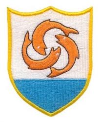 Shield with stylized fish features vibrant orange fish above blue water, set against a clean white background.