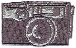 Stylized camera design with a sleek rectangular body, prominent round lens, and detailed buttons in gray tones.