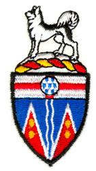 Colorful shield featuring a wolf figure with vibrant blue, red, and yellow details. Decorative style enhances its bold appeal