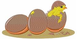 Cheerful chick breaking from an egg with two nearby, grassy eggs, perfect for playful Easter decor.